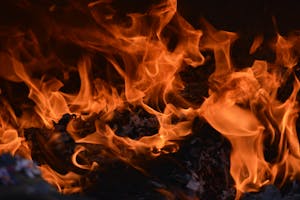 Captivating image of a blazing fire, showcasing intense orange flames and glowing embers.