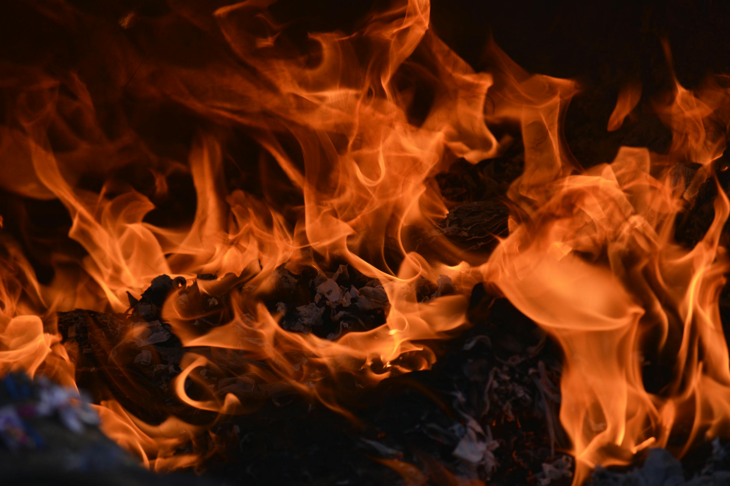 Captivating image of a blazing fire, showcasing intense orange flames and glowing embers.